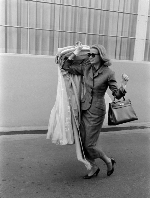 Grace Kelly arriving at Cannes station 1955 with the original Kelly Bag.  With her is her